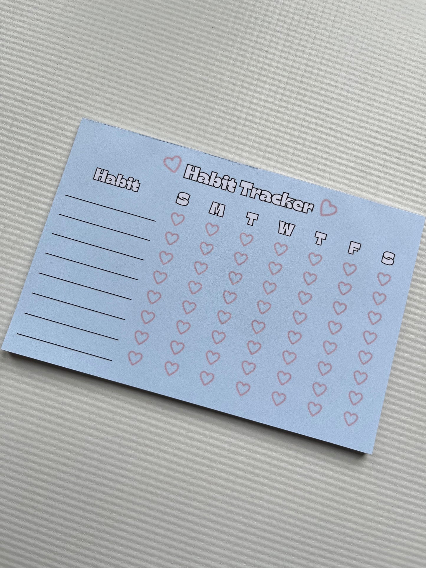 Blue and pink habit tracker notepad