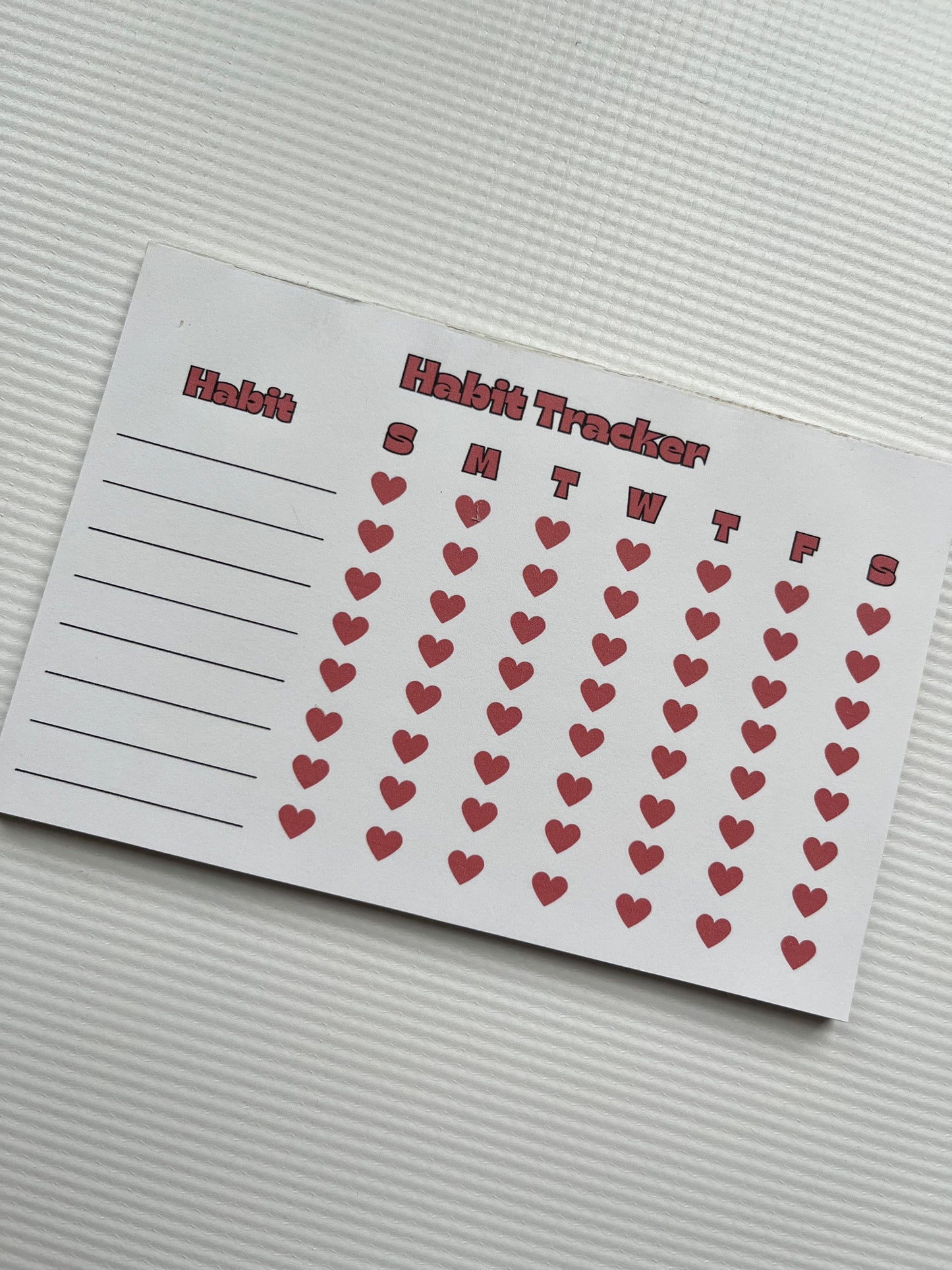Red and cream habit tracker notepad